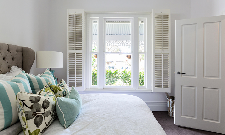 White-coloured wooden window with shutter design in classic style