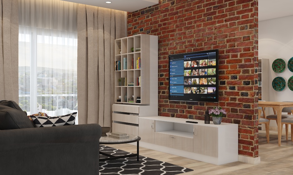 A living room tv unit is positioned against the exposed brick wall